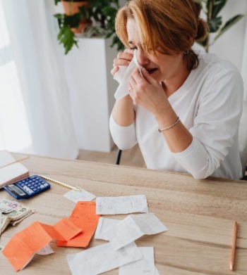 Woman crying over medical bills